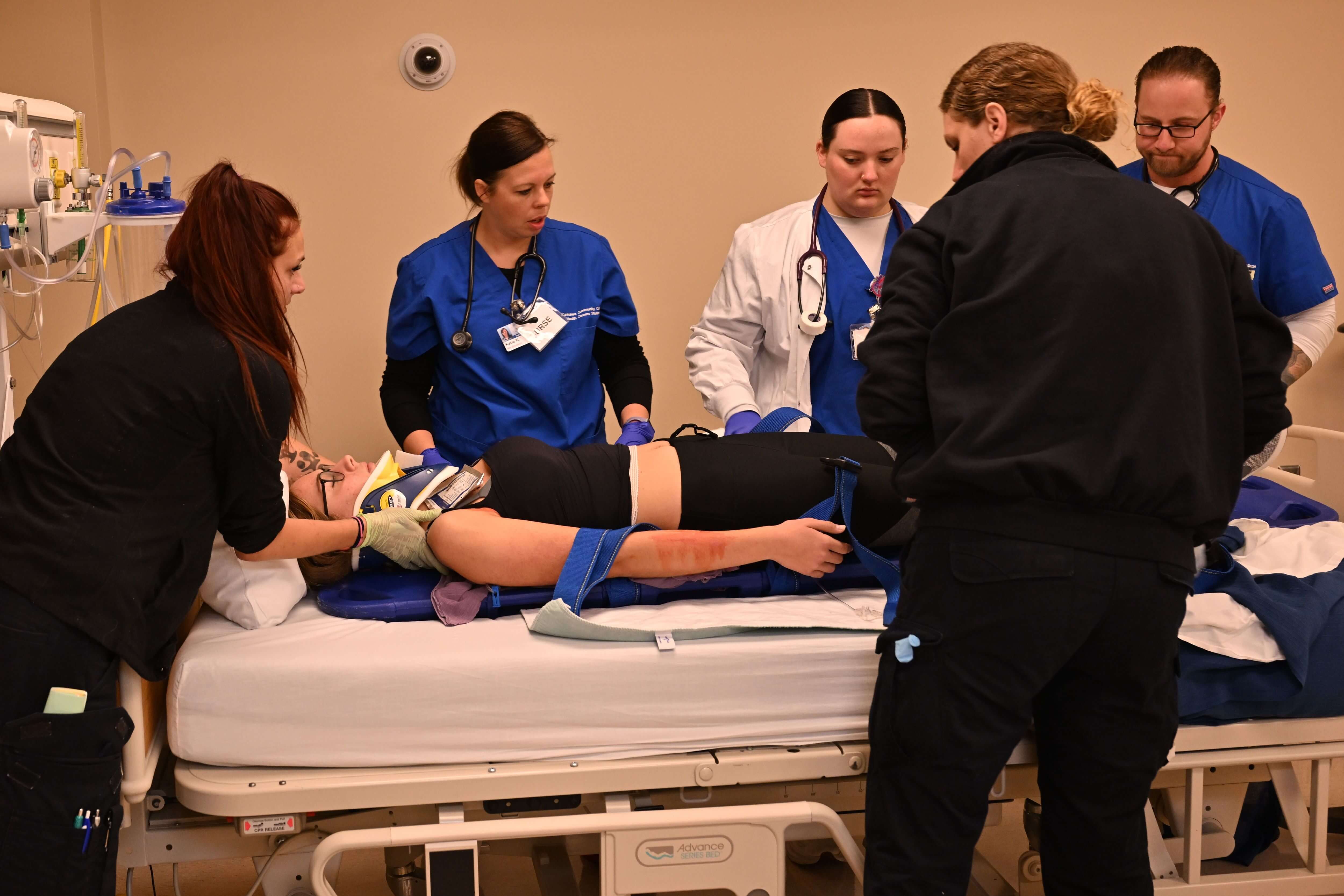 Transfer of patient from paramedic to nursing during KCC Health Careers Simulation October 2024 Z91_5681