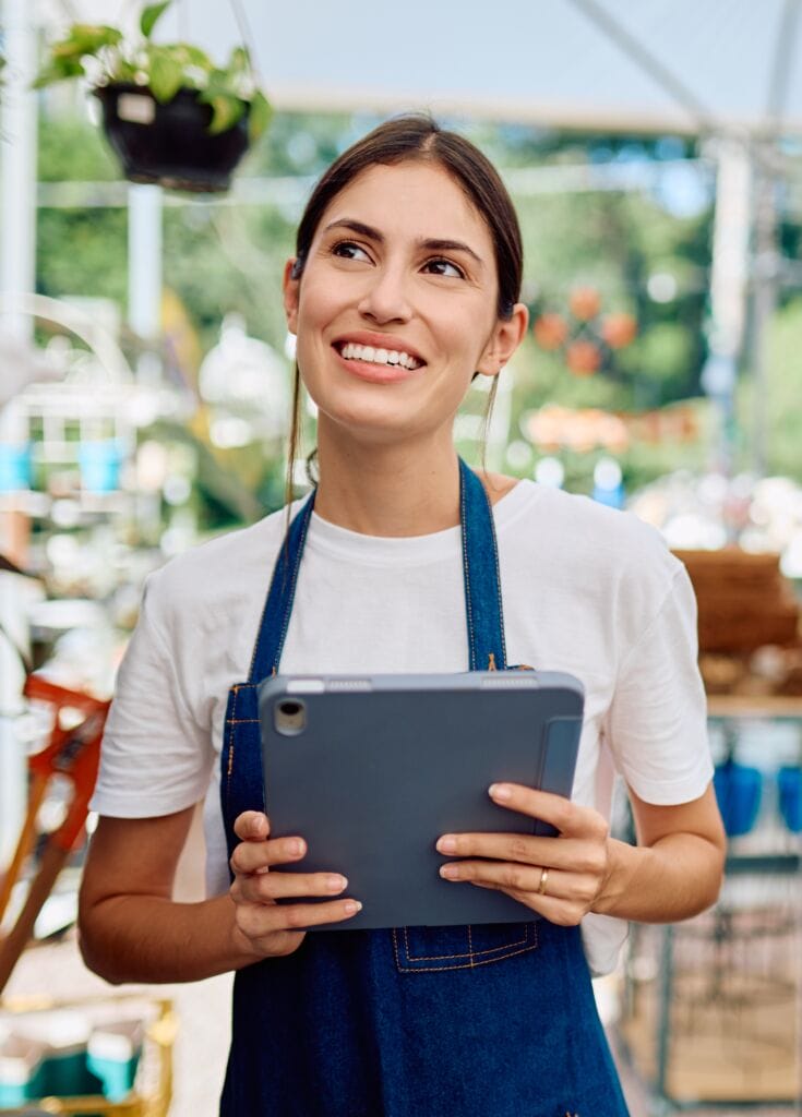 Woman working in garden center with tablet