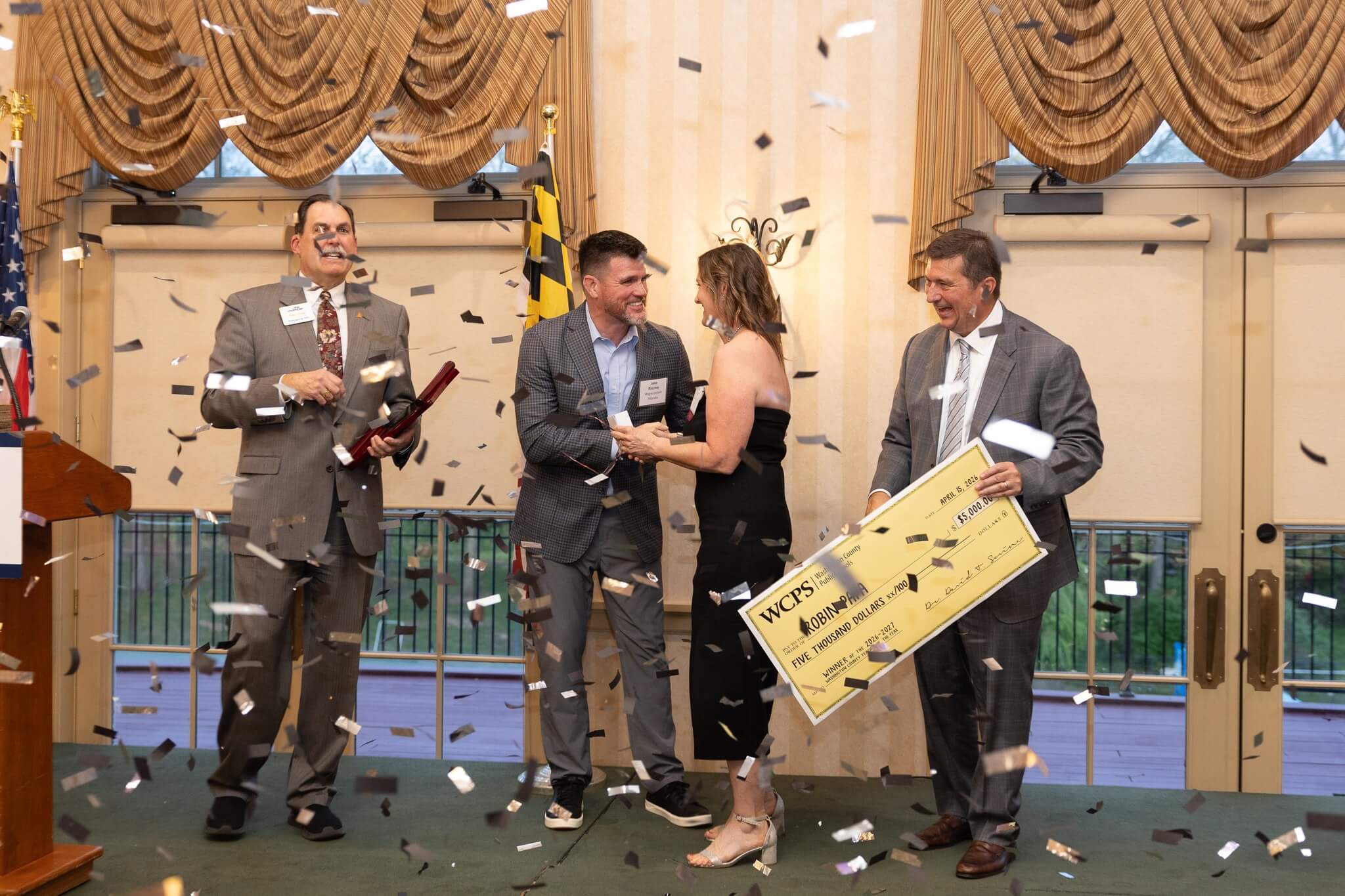 Confetti Cannon goes off as 2026-2027 Teacher of the Year Robin Papas accepts her winnings.