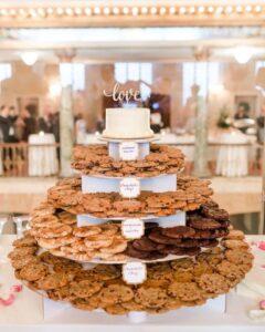 a-large-cookie-stand-with-toppers-and-a-wedding-cake-on-top-is-a-chic-idea-for-any-wedding