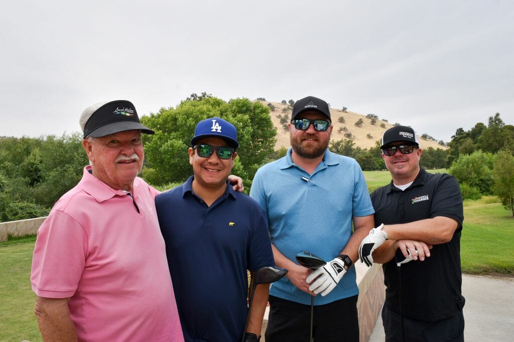 4 guys at a Golf tournament