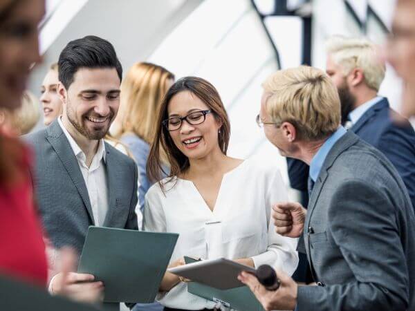 Business professionals networking and collaborating during a meeting, representing teamwork, business growth, and Chamber of Commerce member connections.