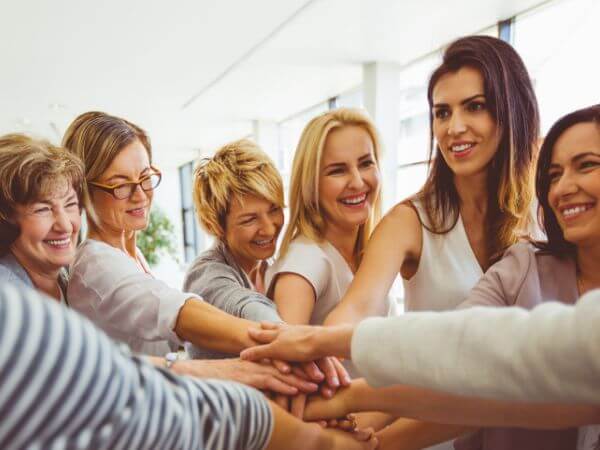 Business professionals participating in a team-building activity, representing collaboration, leadership development, networking, and community engagement.