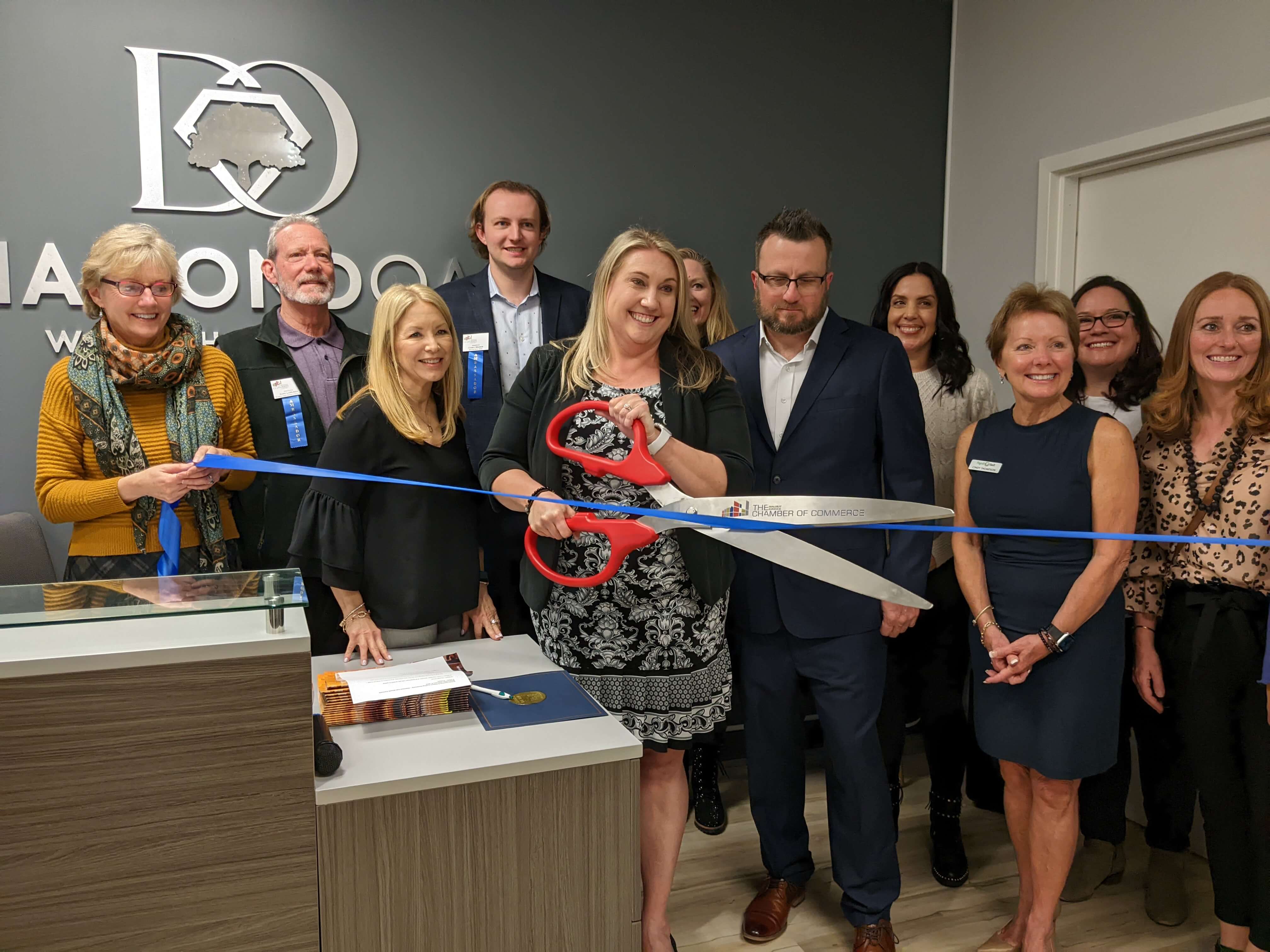 Group participating in the ribbon cutting ceremony for Diamond Oak Wealth Partners