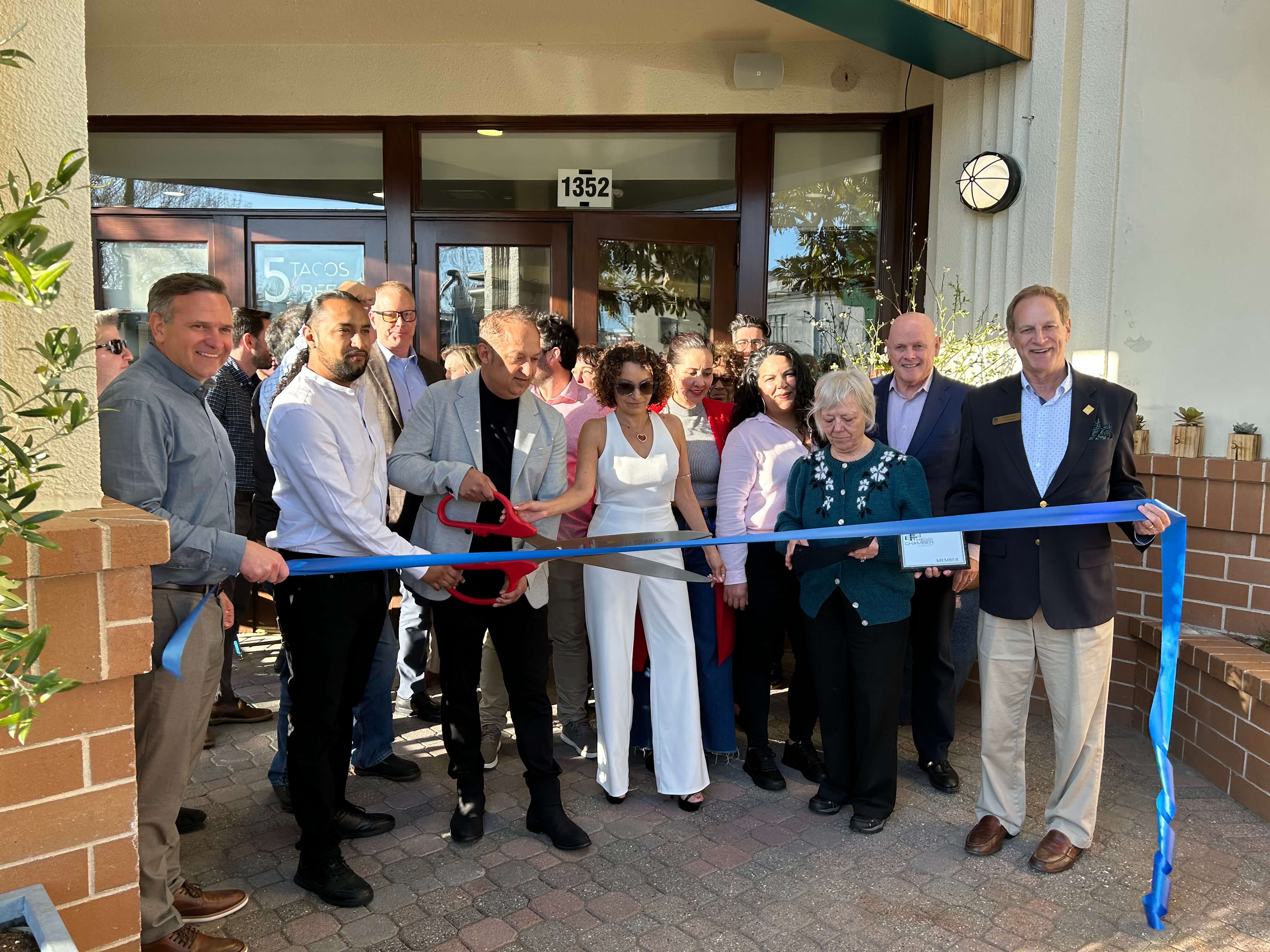 Group celebrating the opening of 5 Tacos & Beers in Walnut Creek with a ribbon cutting