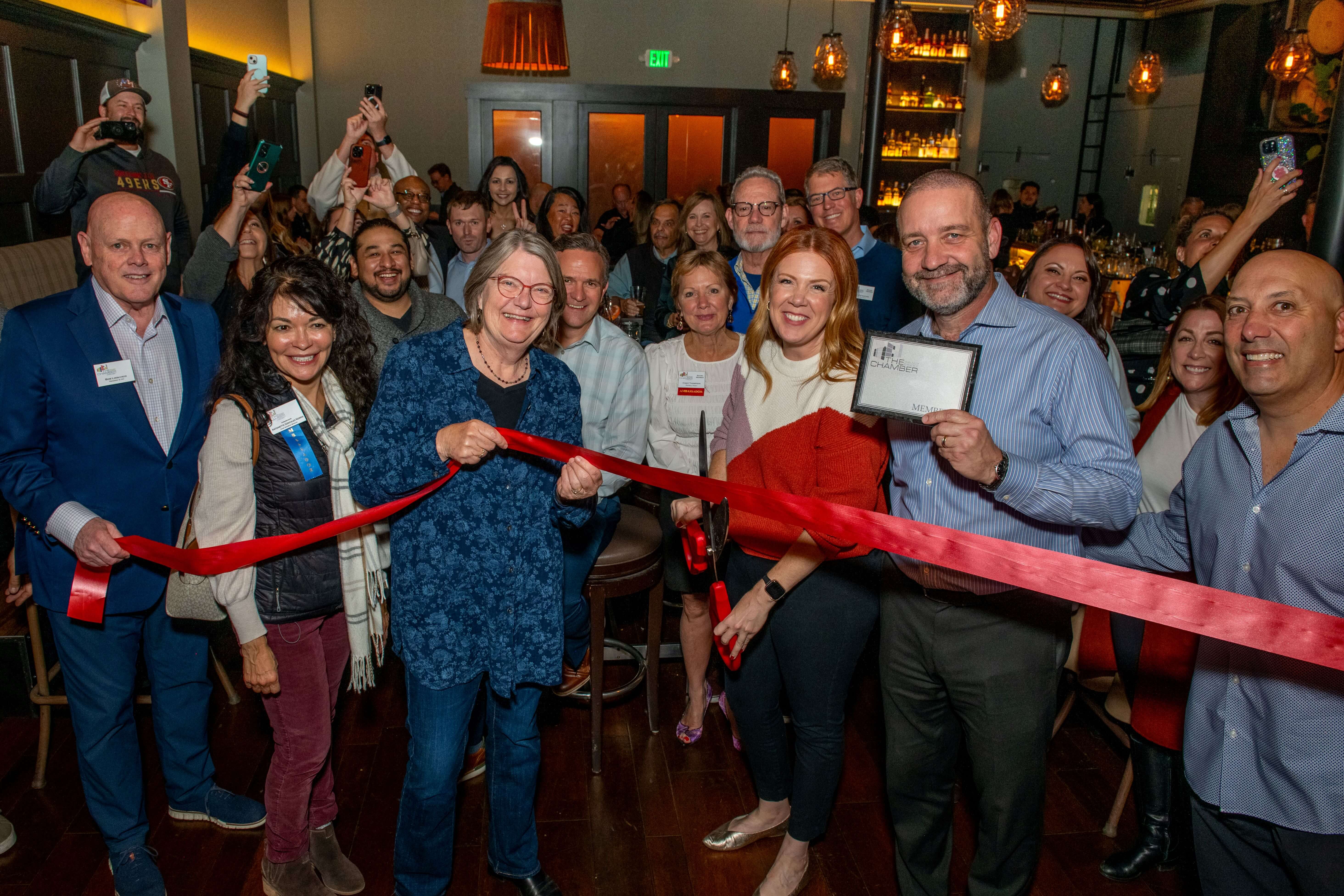 Group celebrating the ribbon cutting at The Cooperage