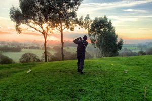 Man taking a swing at a golf ball