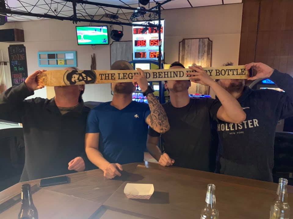 Group of Friend at Our place on 3rd Doing a Shot Ski. Fun Quirky dive bar activity.  