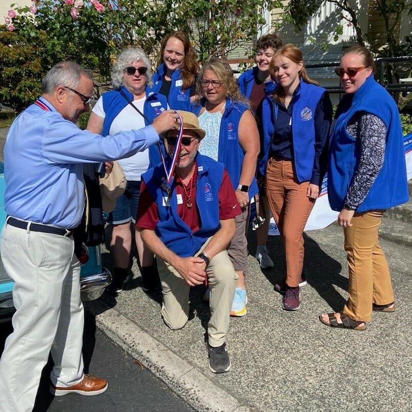 Celebrating the chamber's 150th year in 2023. We were honored to be Grand Marshal of the Regatta Parade on August 12, 2023. 
Kevin Leahy (of Clatsop SBDC) presents the staff with recognition.
Kneeling - David
Left to Right - 
Lois, Isabel, Barbi, Len, Allyson, Regina
(staff not pictured: Nancy, Chris)