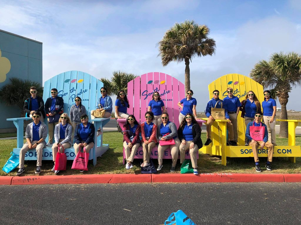 Leadership class group posing on over sized Adirondack chairs