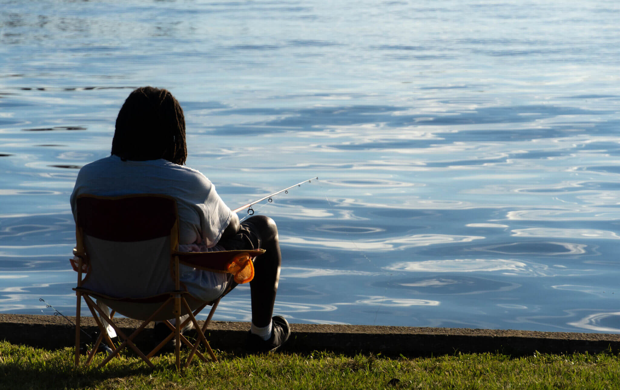 Man sitting by water fishing_Crescent City_Brandy Jo Hastings_ Man sitting by water fishing_Crescent City_Brandy Jo Hastings_