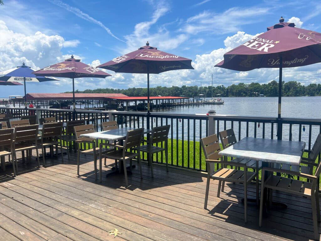 Tables on waterfront dining area at Porkys_Brandy Jo Hastings_