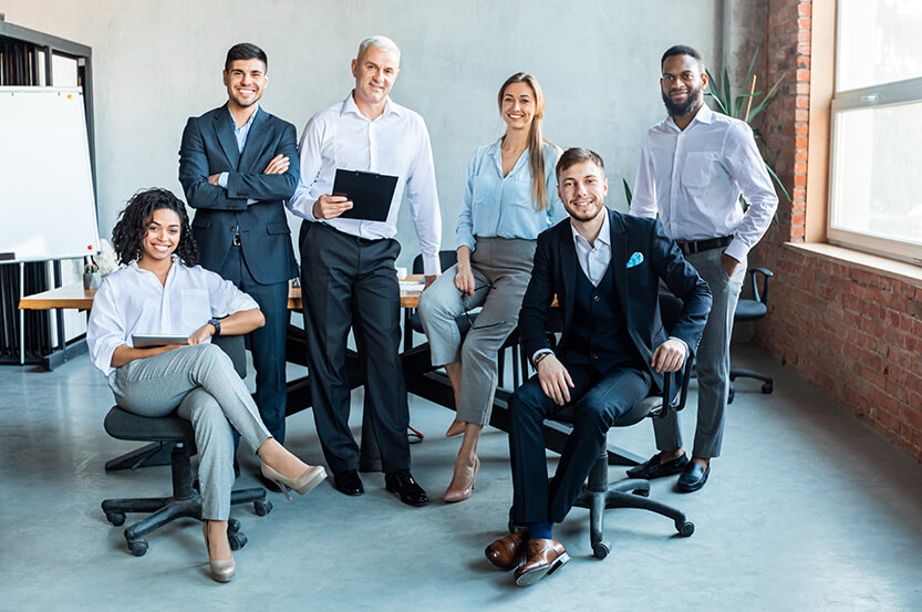 Office Workers. Multiracial Business Team Standing Together Smiling And Posing In Modern Office. Business Career And Teamwork Concept