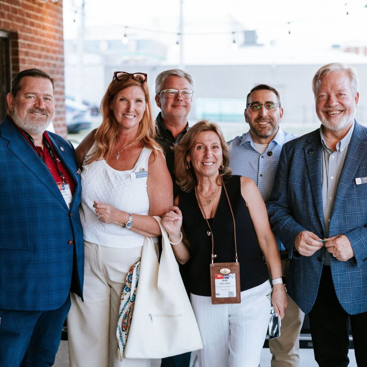 Group of six professionals smiling at camera
