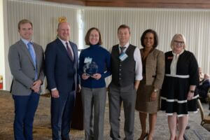 Alabama Lieutenant Governor, Will Ainsworth, Harrison Proctor with Protective Life Corporation, BCA President and CEO, Helena Duncan, and CCAA President and CEO, Paige Hutto presents representatives from Broadway Spinal Care with the Small Business of the Year Award.