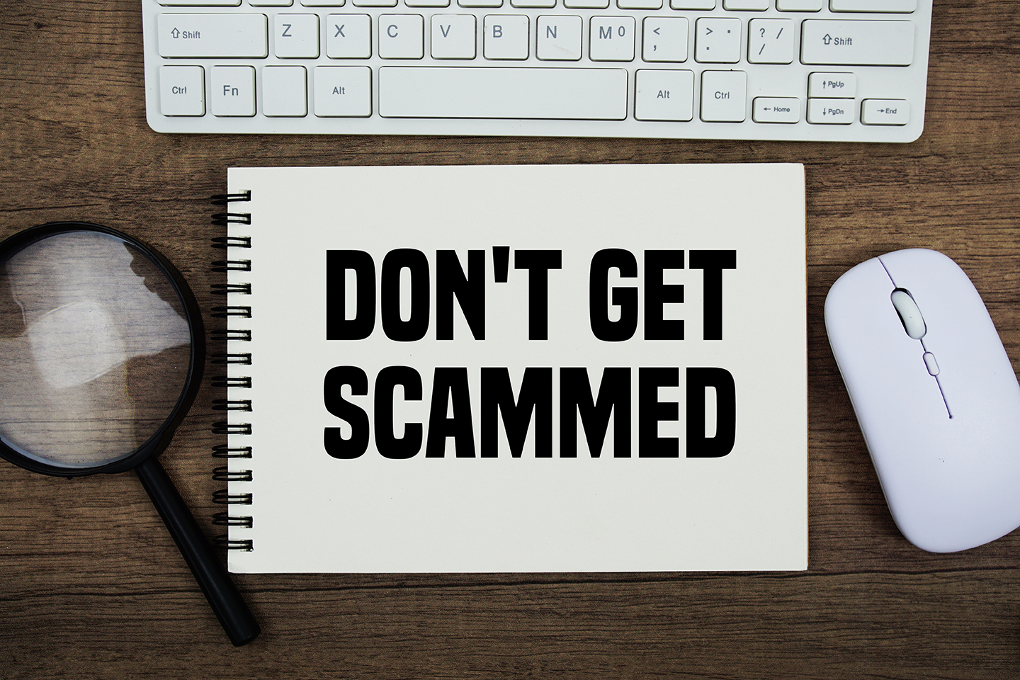 Don't,Get,Scammed,Text,Written,On,Notepad,With,Keyboard,,Optical Don't Get Scammed text written on notepad with keyboard, optical mouse and magnifying glass on wooden background;
