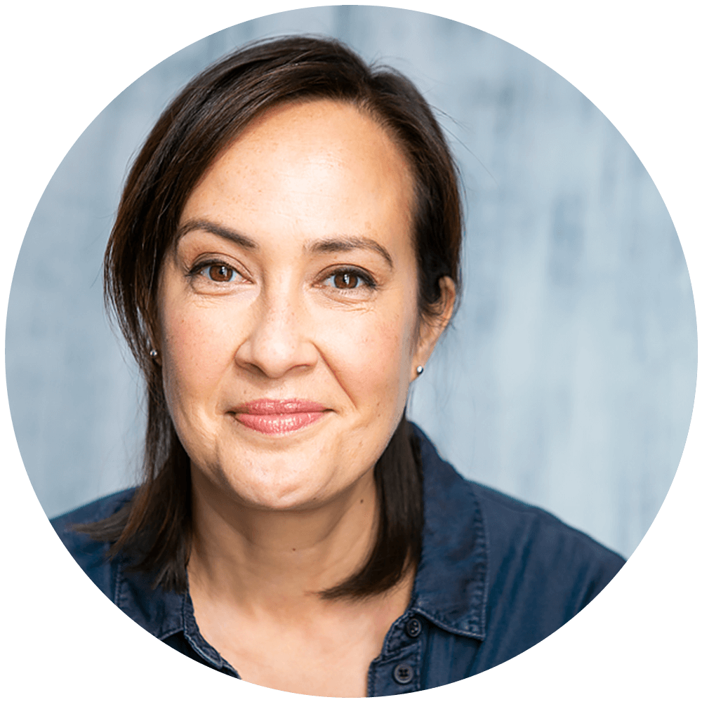 a headshot of actor Katherine Stein wearing a casual collared shirt in blue denim