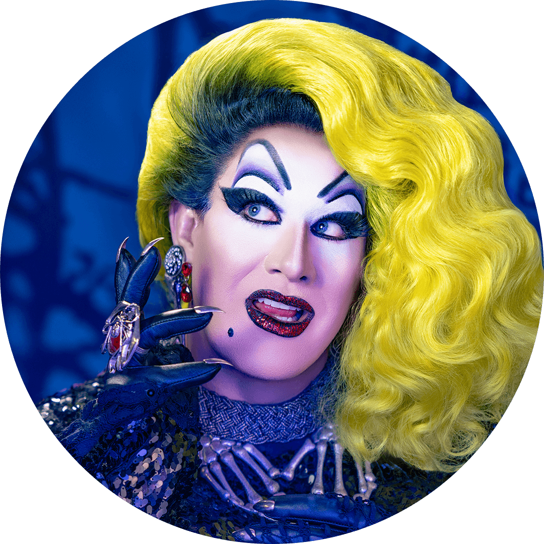 Peaches Christ Drag queen Peaches Christ in a yellow wig with dramatic makeup and red sparkly lipstick against a dark gothic background