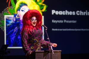 Drag Queen Peaches Christ giving the keynote speech at TBAConnect