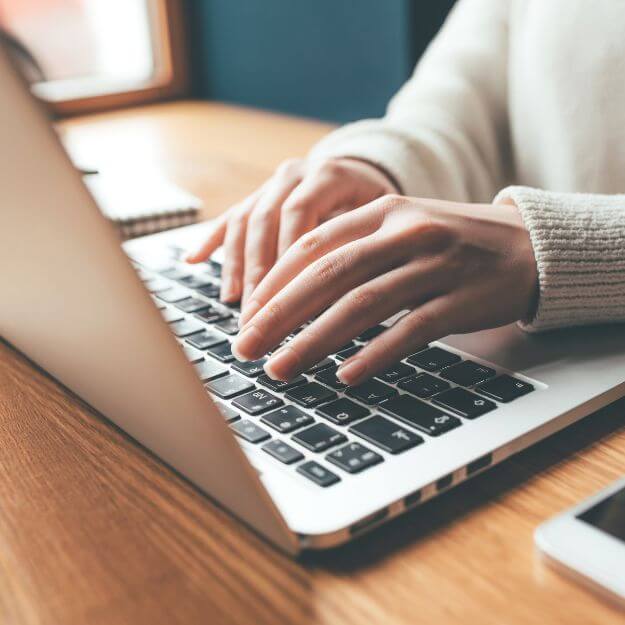 photo of hands on a computer keyboard