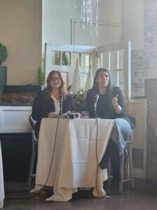 Lauren Siegel & Kristen Gorski -Economic Development Two women sitting a a pub height table