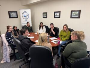 A group of young professionals sitting at a round table