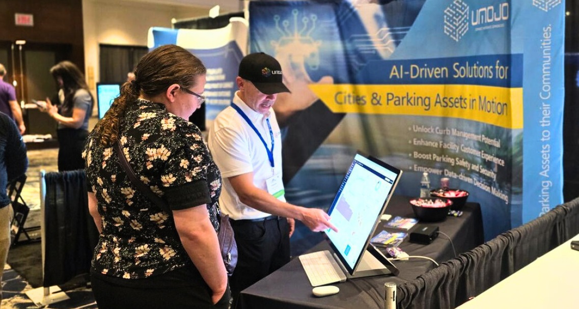 Vendors and attendees talking about parking tech