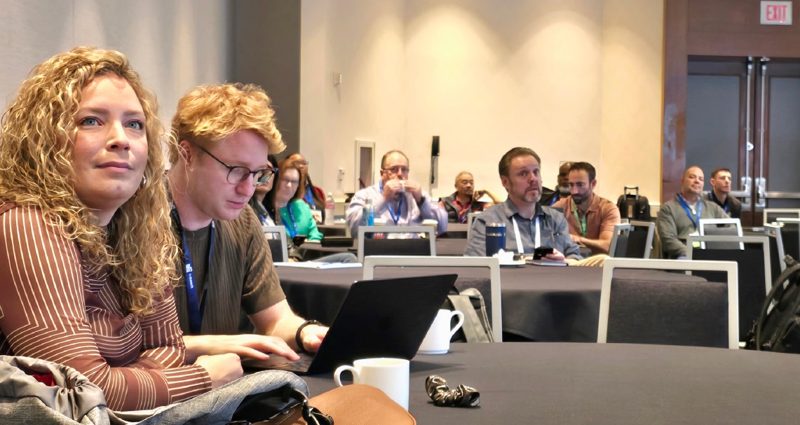 Attendees listening to presenters talk about parking challenges